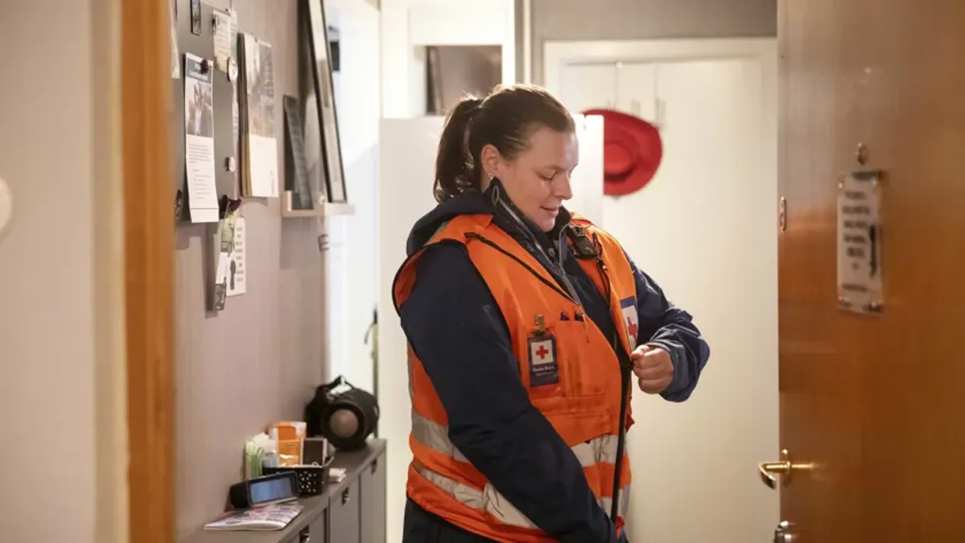 Kvinne tar på seg arbeidsklær