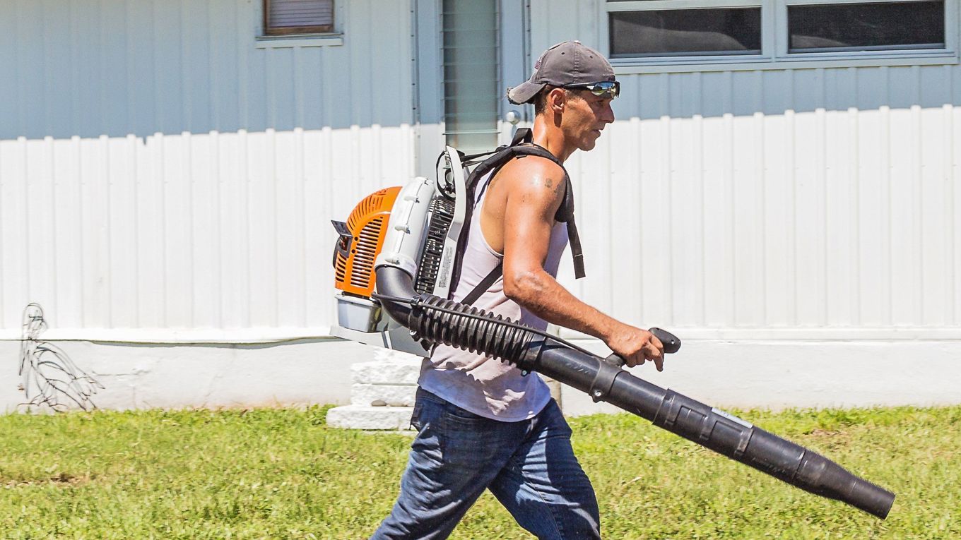 En mann med løvblåser